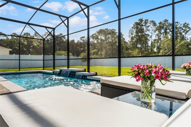 view of pool featuring a patio, pool water feature, glass enclosure, and a jacuzzi