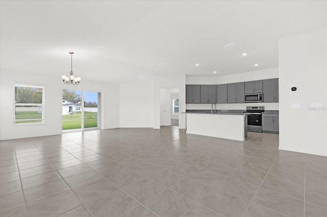 unfurnished living room featuring an inviting chandelier, light tile patterned floors, a sink, and recessed lighting