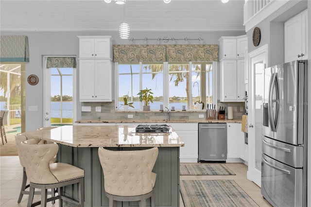 kitchen with white cabinetry, light stone countertops, and stainless steel appliances