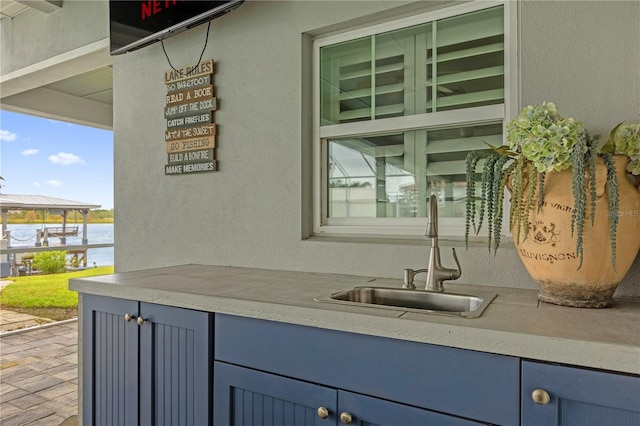 view of patio featuring sink and a water view