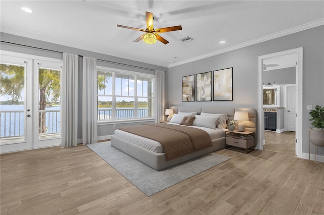 bedroom with ceiling fan, access to exterior, light hardwood / wood-style flooring, french doors, and a water view