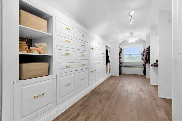 hallway featuring hardwood / wood-style floors and vaulted ceiling