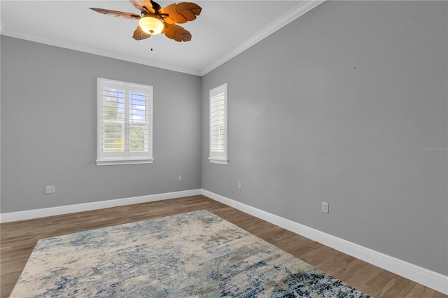 empty room with ornamental molding, hardwood / wood-style flooring, and ceiling fan