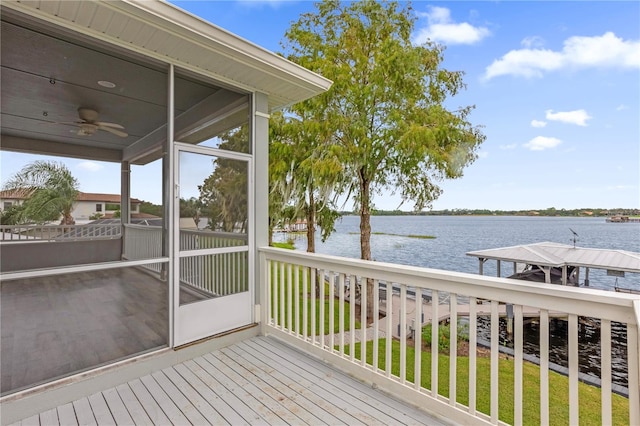 deck featuring a water view, ceiling fan, and a sunroom