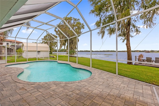 view of swimming pool with a water view, a patio area, glass enclosure, and a yard