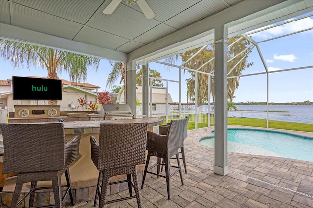 exterior space featuring a pool, ceiling fan, a water view, and plenty of natural light