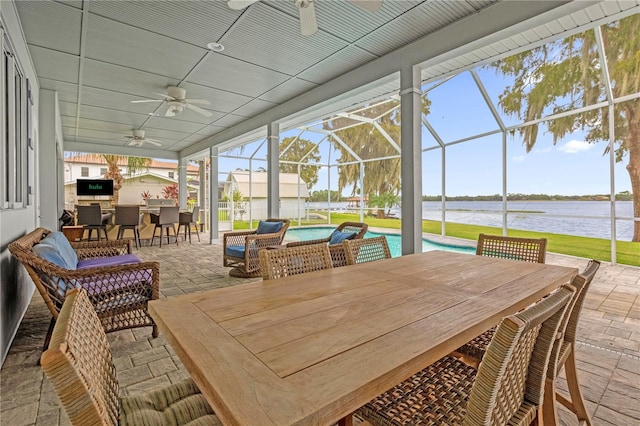 sunroom / solarium featuring a swimming pool, a water view, and ceiling fan