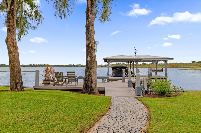 dock area featuring a water view and a lawn