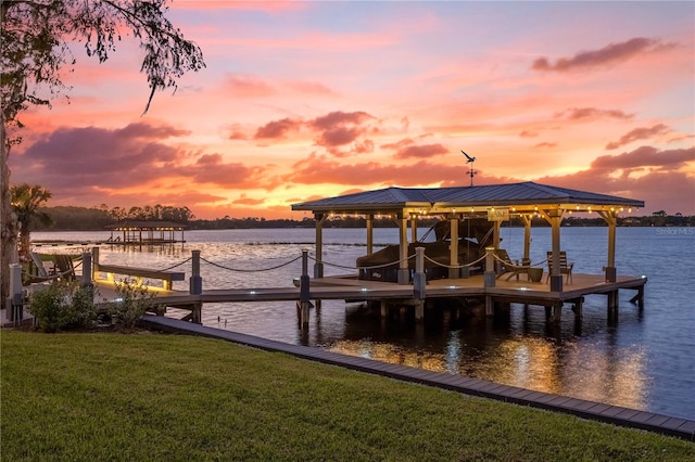 dock area with a yard and a water view