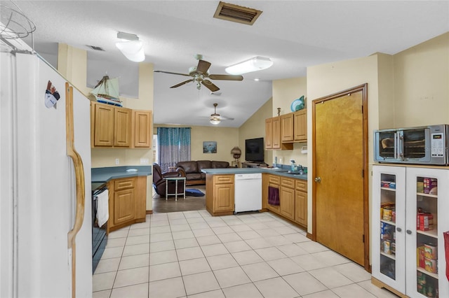 kitchen with kitchen peninsula, ceiling fan, vaulted ceiling, light tile patterned flooring, and white appliances