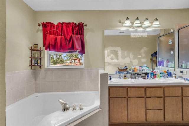 bathroom featuring vanity and shower with separate bathtub