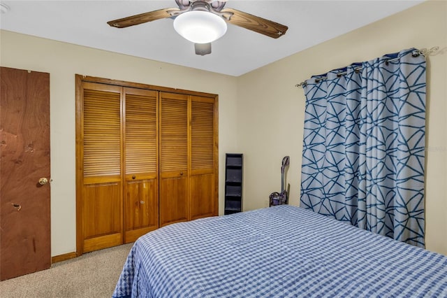 bedroom with a closet, ceiling fan, and light colored carpet