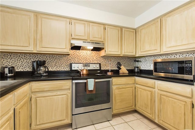 kitchen featuring decorative backsplash, appliances with stainless steel finishes, light brown cabinets, and light tile patterned floors