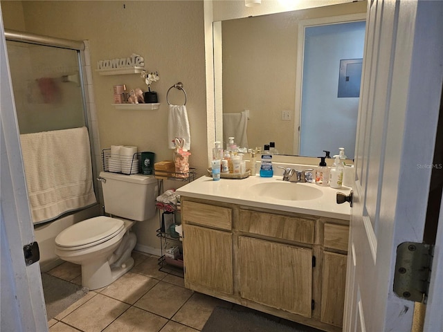 full bathroom featuring tile patterned floors, vanity, bath / shower combo with glass door, and toilet