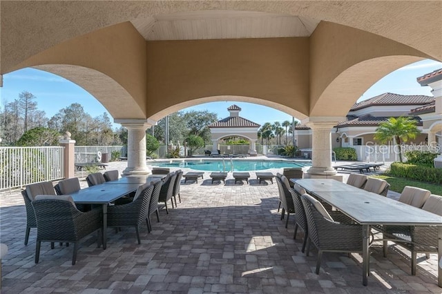 view of patio with a gazebo and a community pool