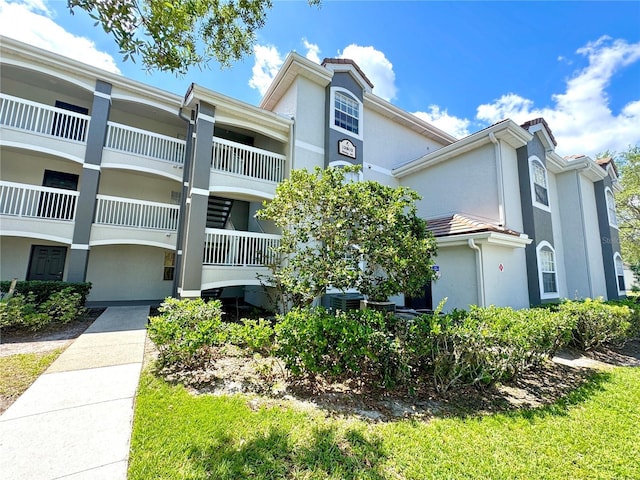 13803 Fairway Island Dr Unit 1627, Orlando, FL 32837 - view of building exterior featuring central AC unit