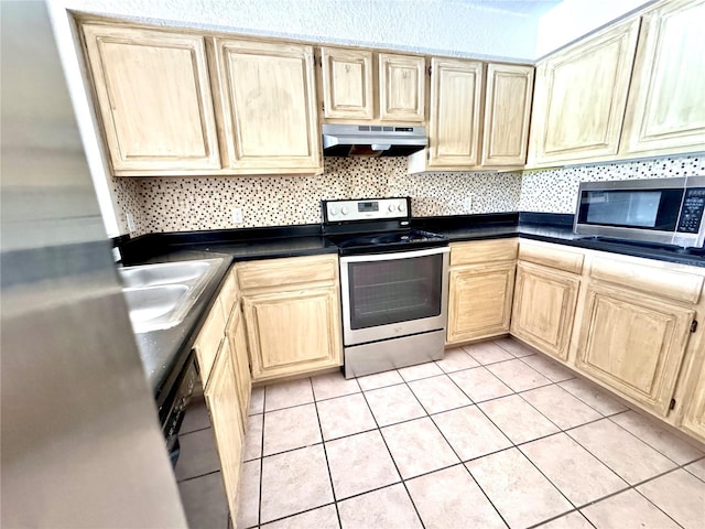 13803 Fairway Island Dr Unit 1627, Orlando, FL 32837 - kitchen with appliances with stainless steel finishes, under cabinet range hood, light brown cabinets, and dark countertops