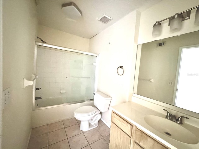 13803 Fairway Island Dr Unit 1627, Orlando, FL 32837 - bathroom with toilet, tile patterned flooring, vanity, bath / shower combo with glass door, and baseboards