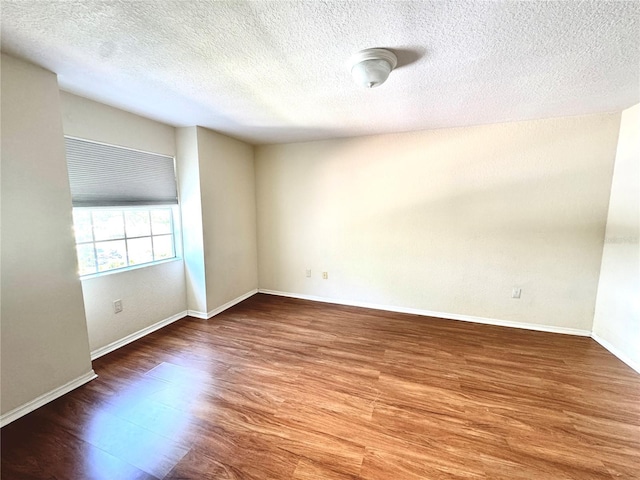 13803 Fairway Island Dr Unit 1627, Orlando, FL 32837 - unfurnished room featuring wood finished floors, a textured ceiling, and baseboards