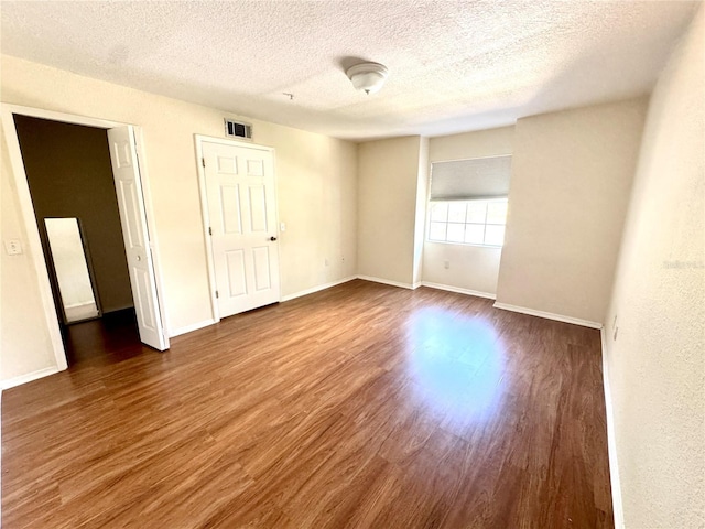 13803 Fairway Island Dr Unit 1627, Orlando, FL 32837 - unfurnished room with wood finished floors, a textured ceiling, and baseboards