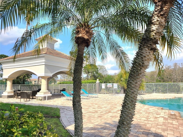 13803 Fairway Island Dr Unit 1627, Orlando, FL 32837 - community pool featuring a gazebo, fence, and a patio