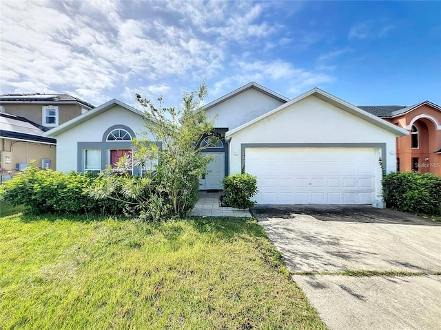 view of front of house featuring a garage and a front lawn