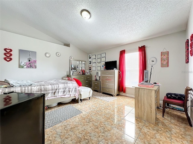 tiled bedroom featuring a textured ceiling and vaulted ceiling