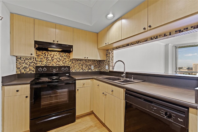 kitchen with decorative backsplash, light brown cabinetry, black appliances, light hardwood / wood-style floors, and sink