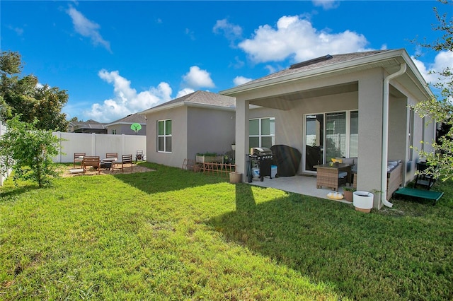 rear view of property featuring a yard and a patio