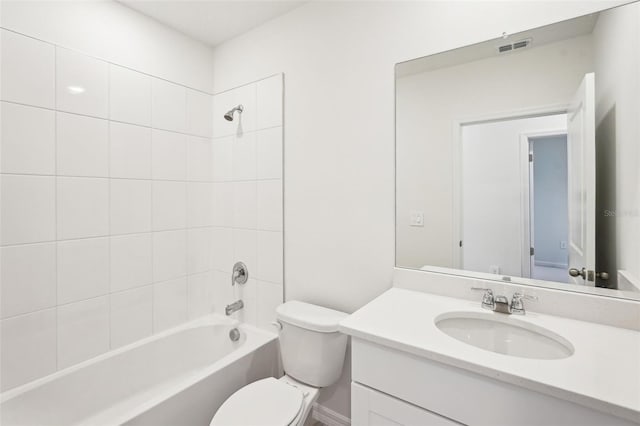 full bathroom featuring toilet, vanity, and tiled shower / bath