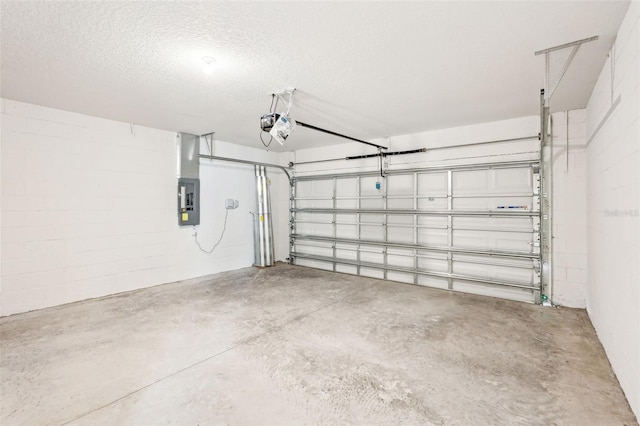 garage with electric panel and a garage door opener