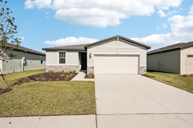 view of front of home with a front yard and a garage