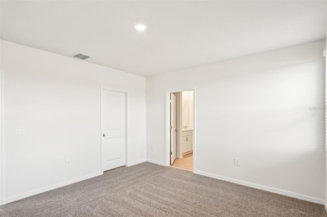 empty room with light colored carpet