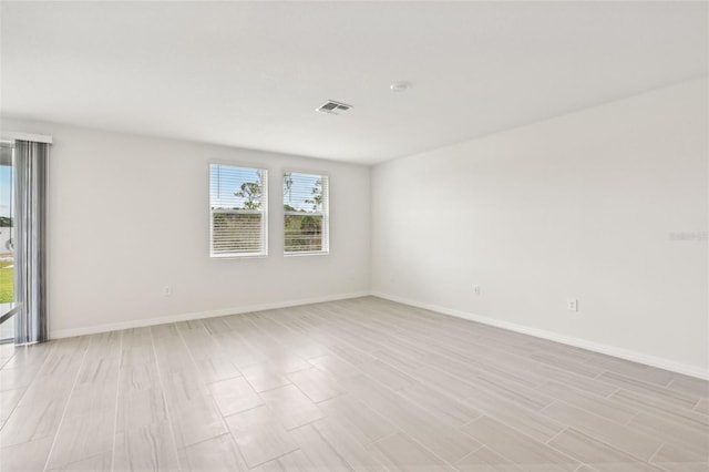 spare room featuring light hardwood / wood-style flooring