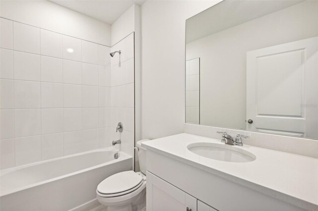 full bathroom featuring vanity, toilet, and tiled shower / bath