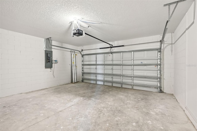 garage with a garage door opener and electric panel