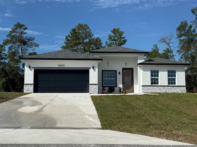 prairie-style home with a garage and a front lawn