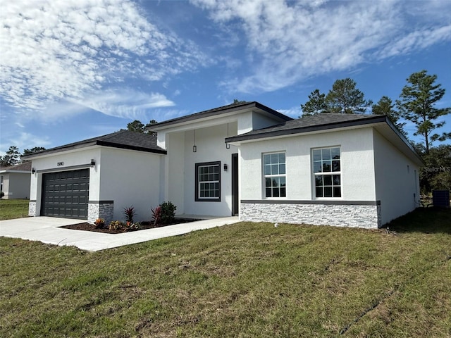 view of front facade with a garage and a front lawn