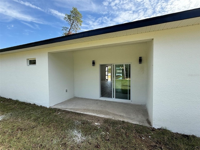 property entrance with a patio