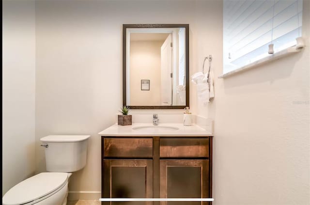 bathroom with vanity, toilet, and tile patterned flooring