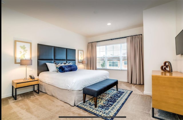 bedroom featuring light colored carpet