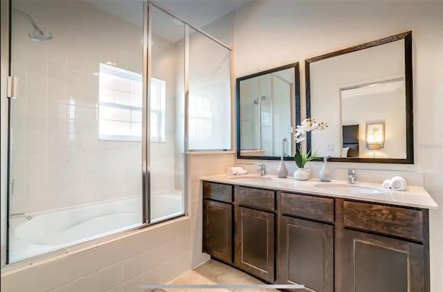 bathroom featuring bath / shower combo with glass door and vanity