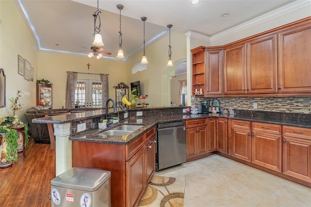 kitchen featuring kitchen peninsula, dark stone counters, sink, decorative light fixtures, and dishwasher