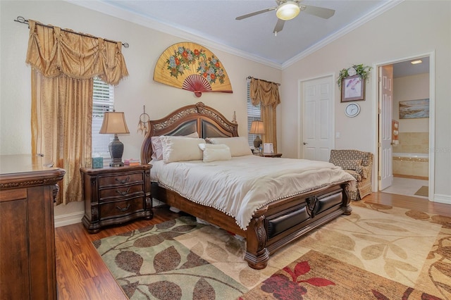 bedroom featuring ensuite bathroom, ornamental molding, vaulted ceiling, ceiling fan, and hardwood / wood-style flooring