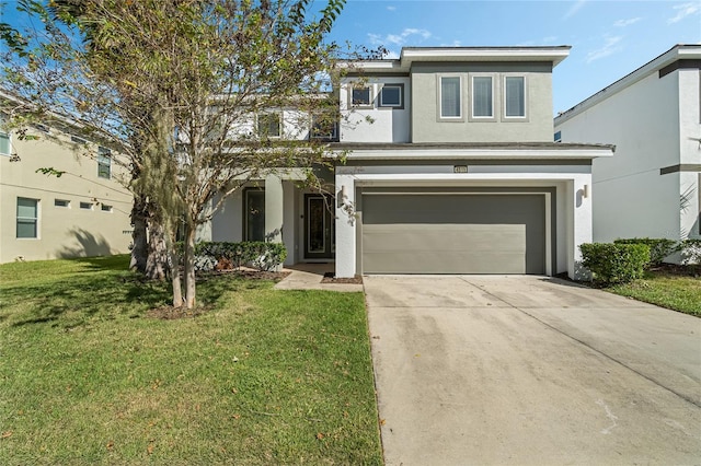 view of property featuring a front yard and a garage