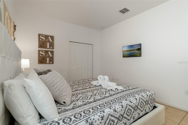 bedroom featuring a closet and light tile patterned floors