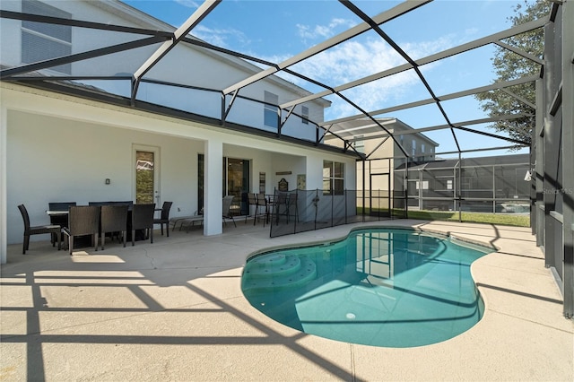 view of pool featuring a patio and glass enclosure