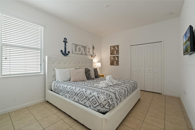 tiled bedroom with a closet