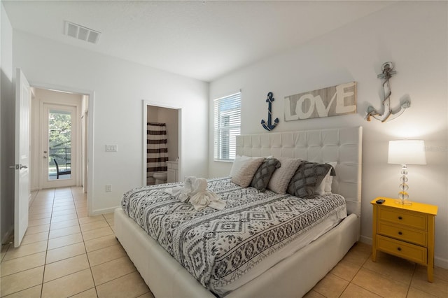 bedroom with multiple windows and light tile patterned floors