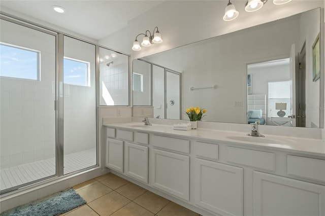 bathroom with vanity, a shower with shower door, and tile patterned floors